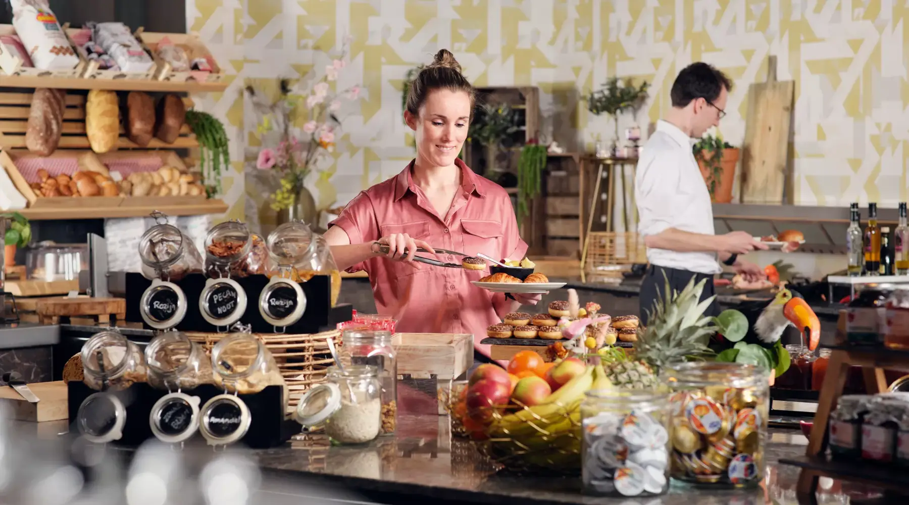 Die Dame steht am Frühstücksbuffet.