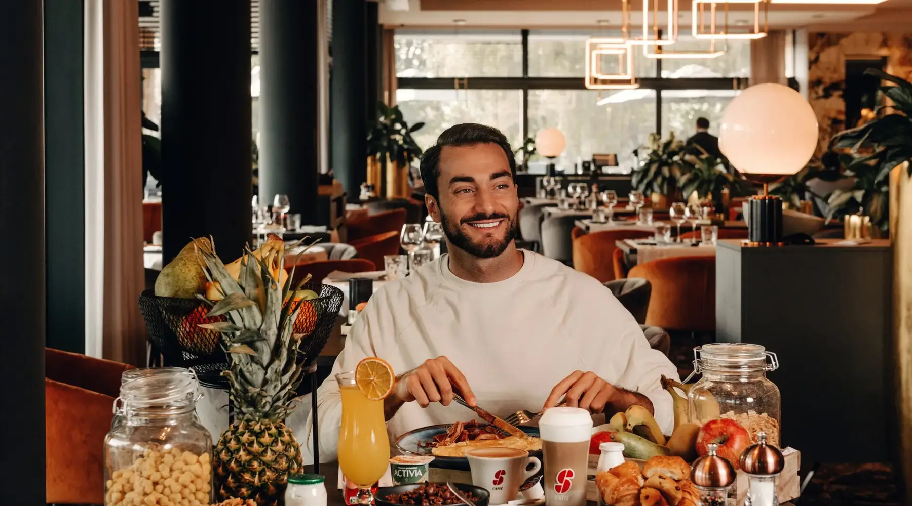 Generous breakfast buffet at Van der Valk Nivelles-Sud: artisan pastries, fresh fruit, and eggs cooked to order.