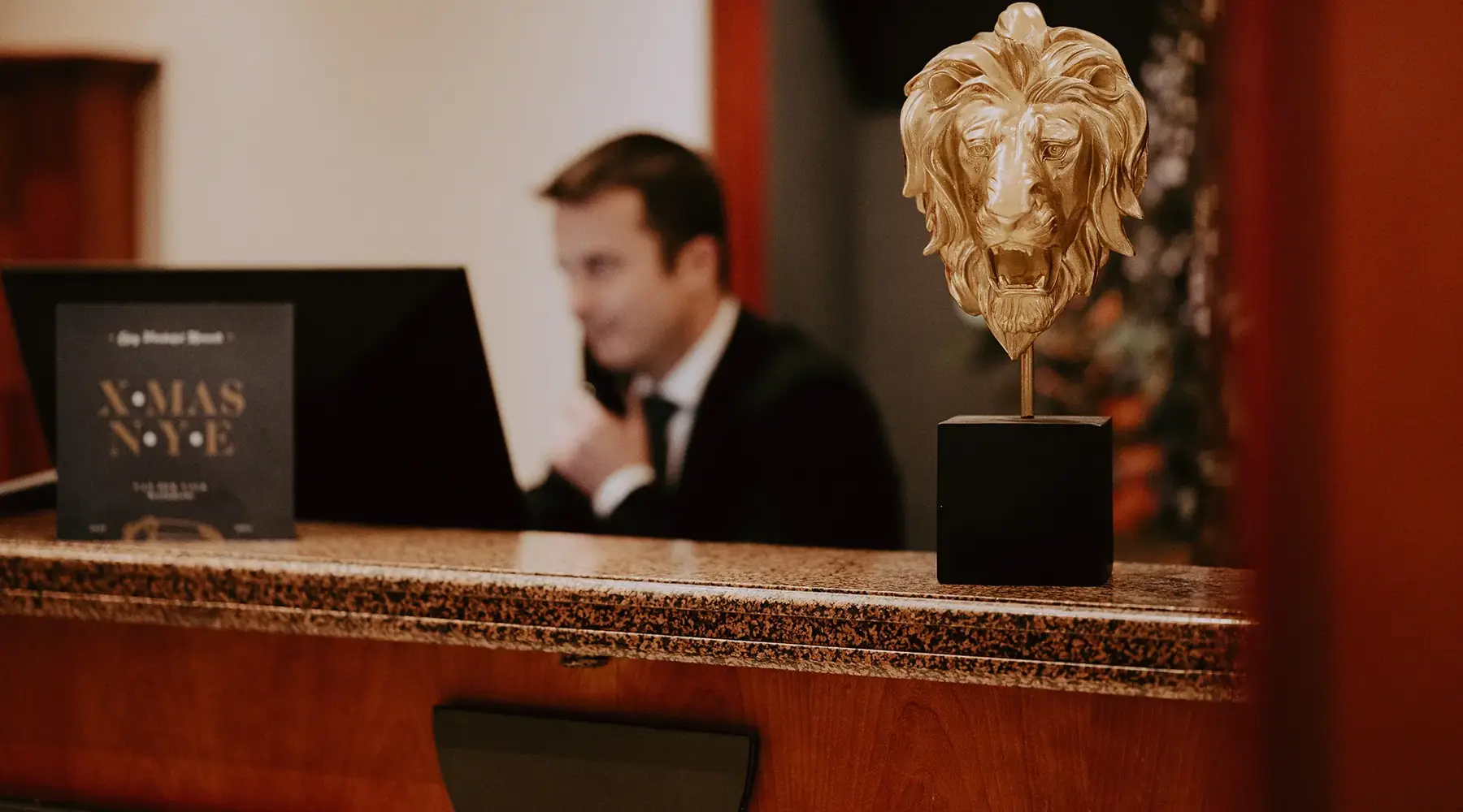 Friends checking in at the reception of a hotel
