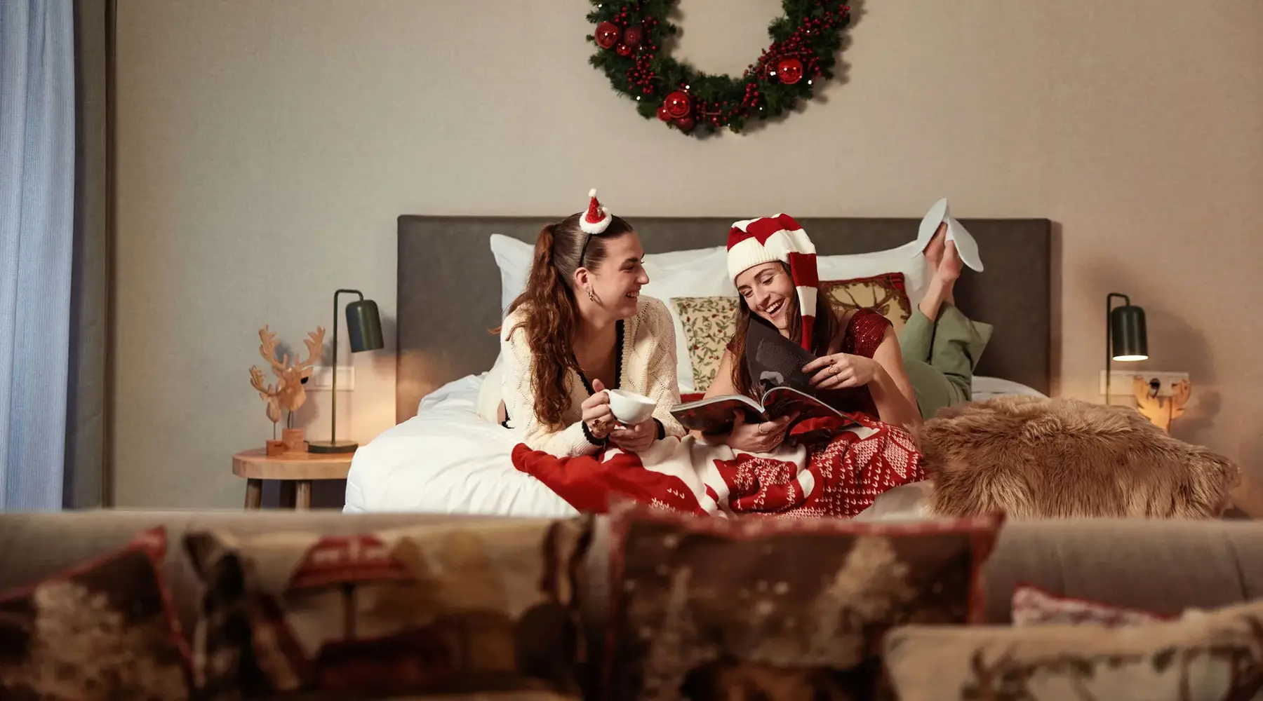 Girlfriends in a decorated Christmas hotel room