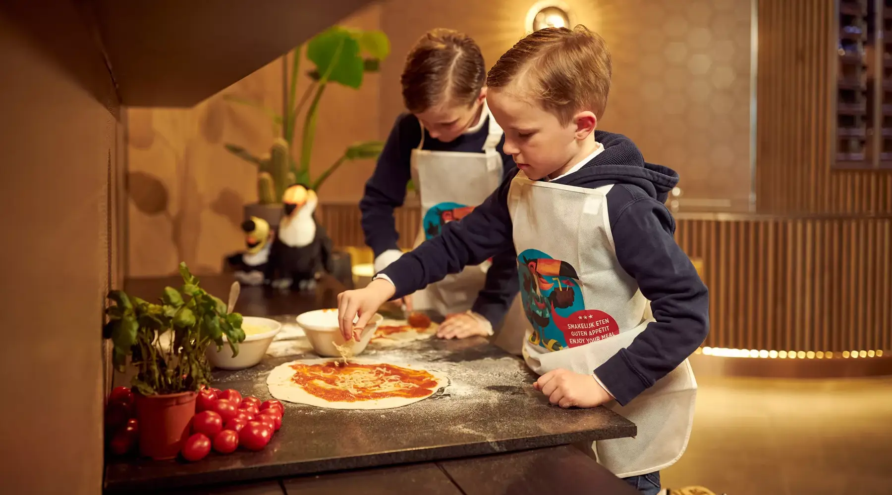 Child makes pizza in the restaurant
