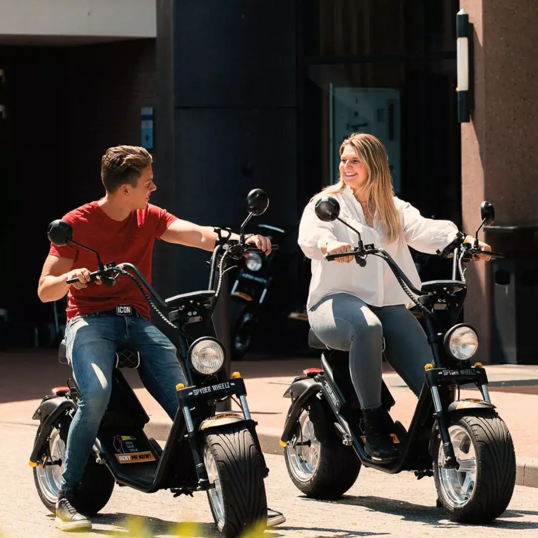 2 people on an e-chopper