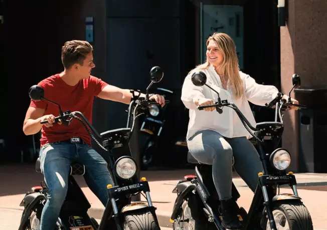 2 people on an e-chopper