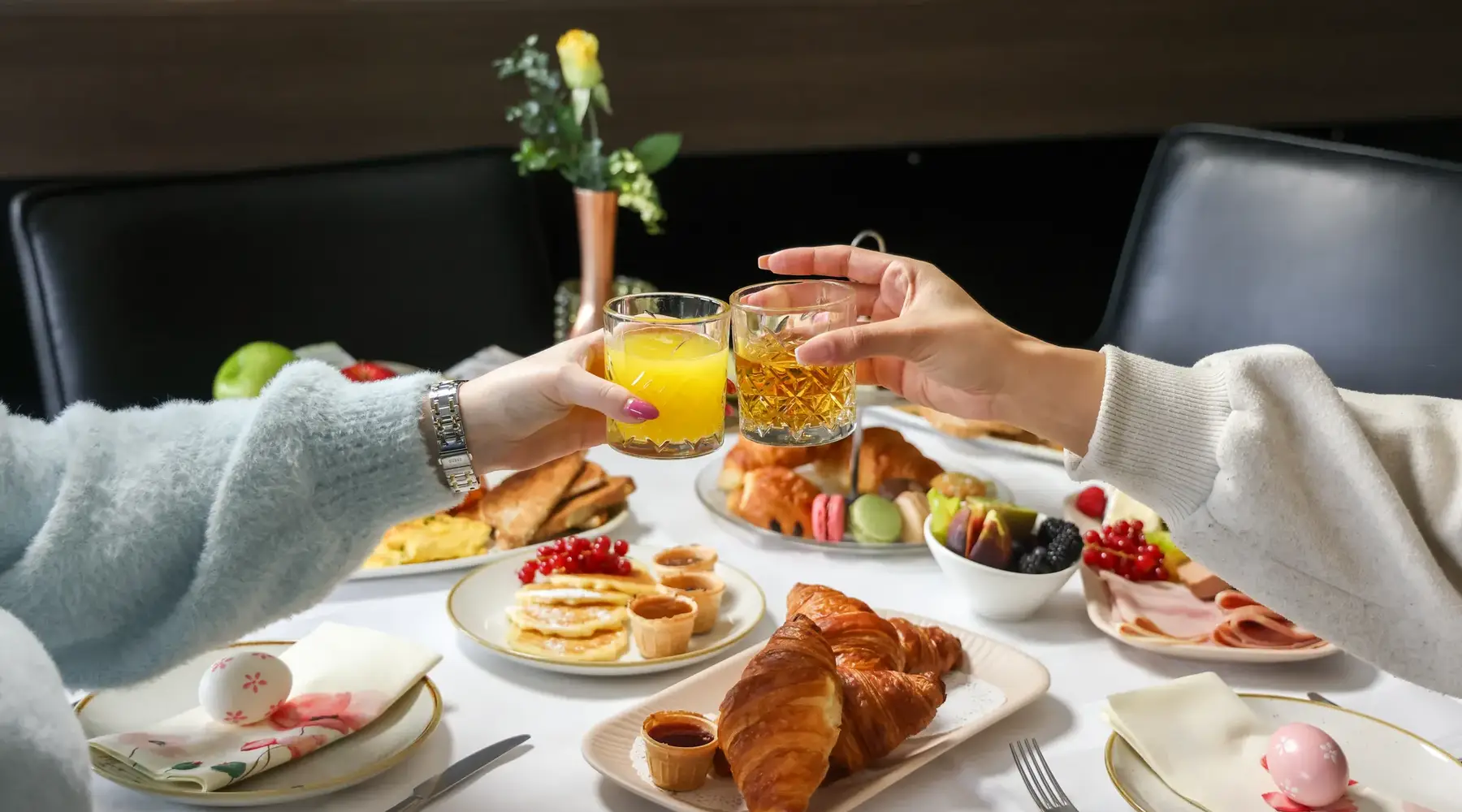 Set Easter table during an Easter brunch where 2 people toast
