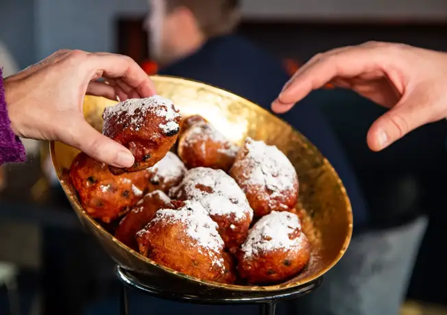 Glasses of champagne with a plate of oliebollen