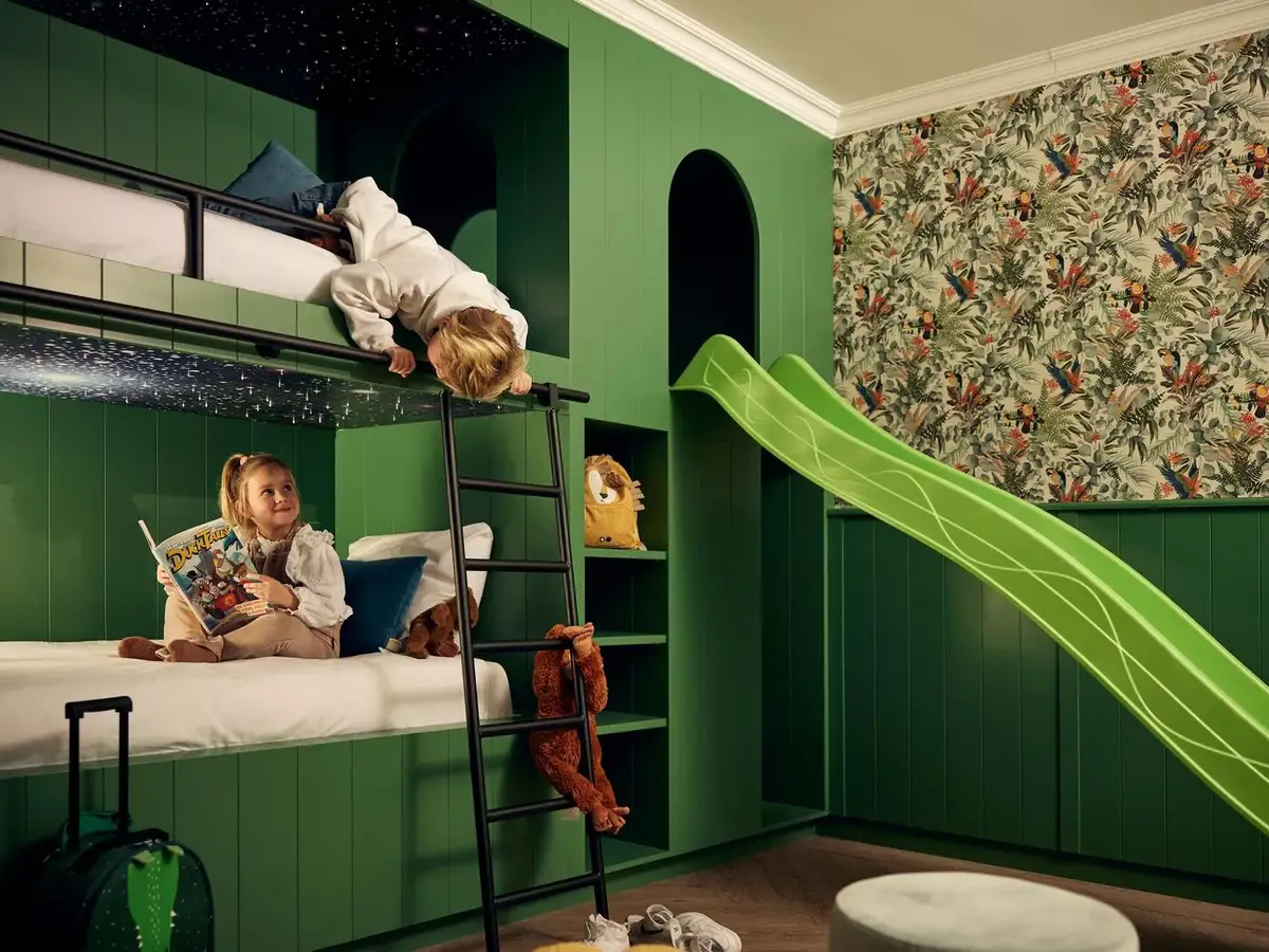 2 kids on a bunk bed with slide