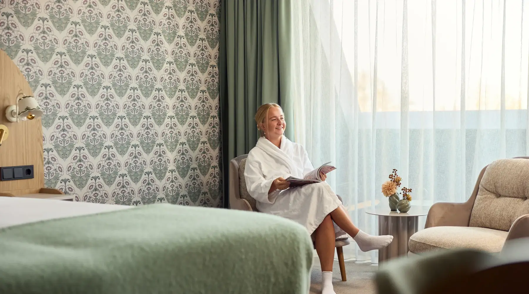 Woman in a bathrobe in her hotel room