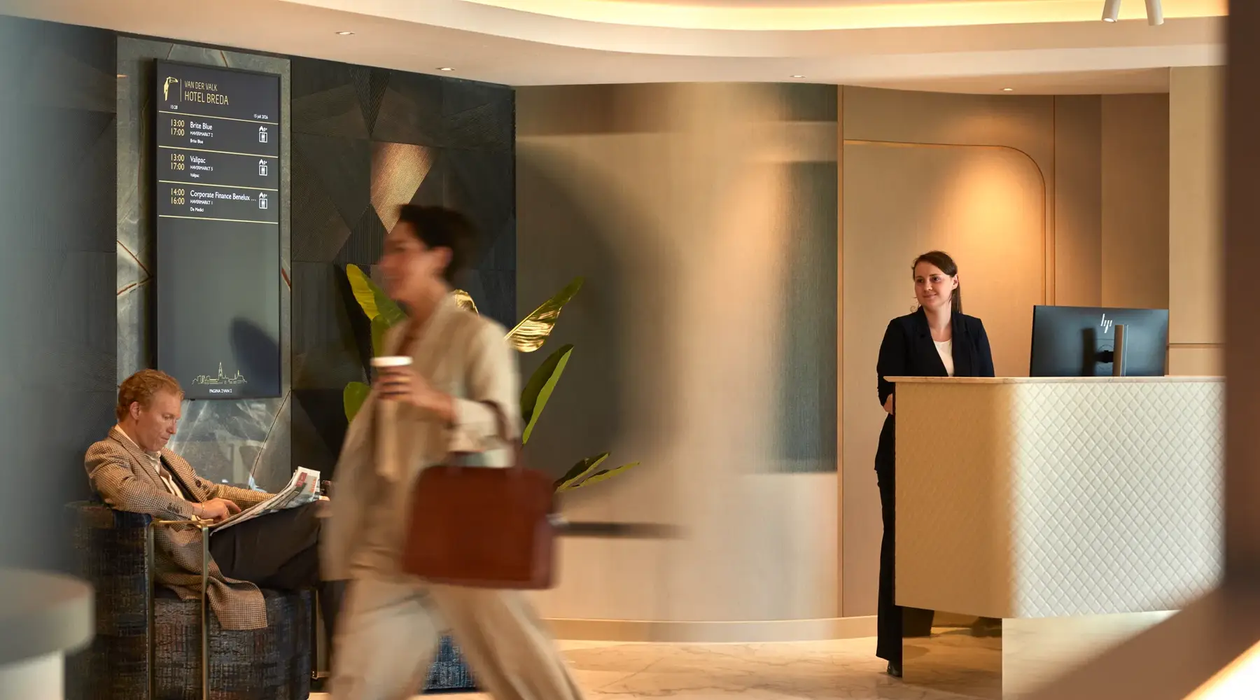 Guests walk through the lobby of the Hotel Breda Business Center