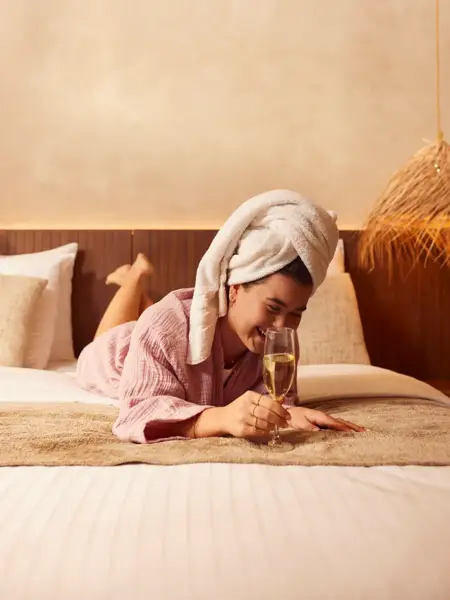 Woman with towel in her hair on bed