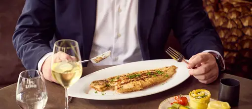 Man enjoys a North Sea sole fried in butter at Restaurant Vloed