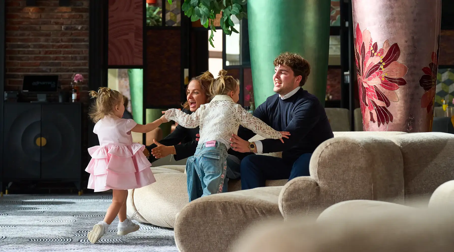 Children run to their father in a hotel