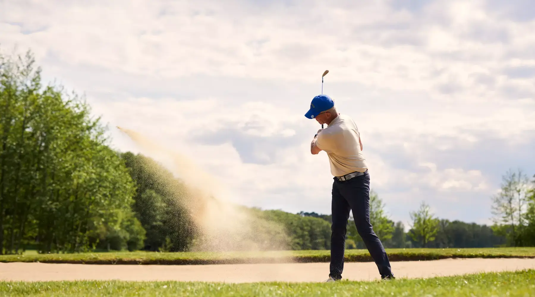 A man hits a golf ball