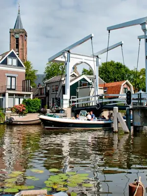 Boat passes under bridge in Breukelen