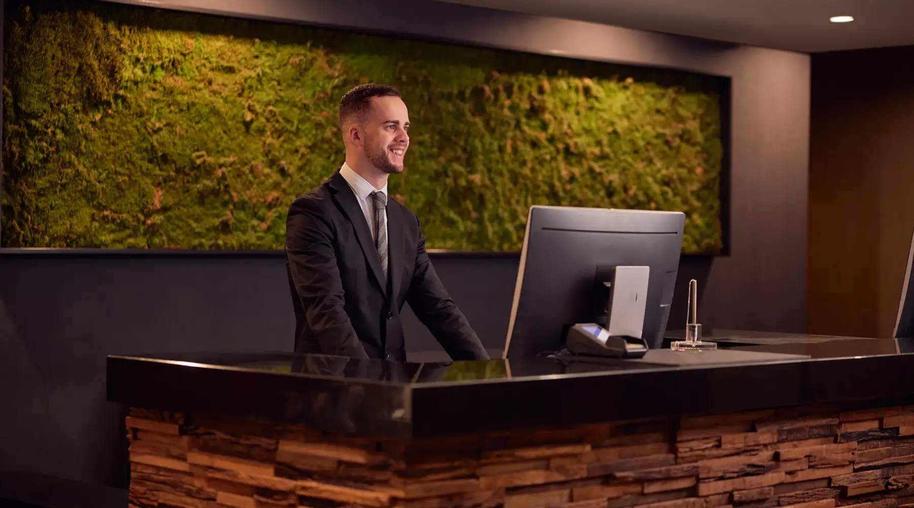 Friends checking in at the reception of a hotel