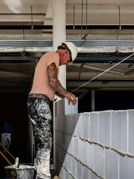  A builder builds a wall