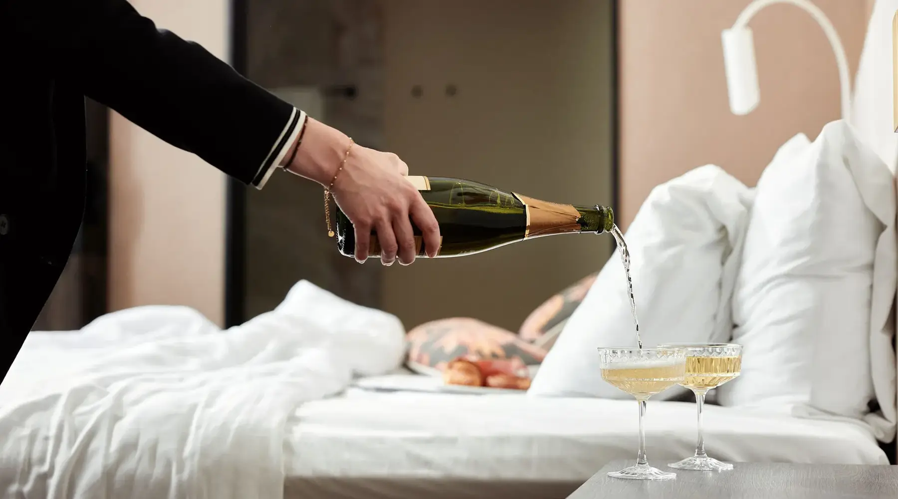 Champagne is poured in a hotel room