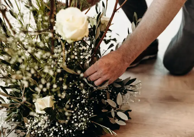 A bouquet of flowers is being arranged.