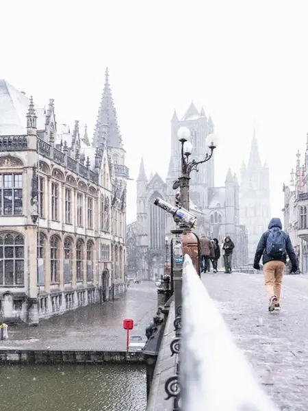 Visitors enjoy the magical Christmas market in Ghent, featuring the iconic Ferris wheel and festive lights, perfectly combined with a stay at Van der Valk Hotel Ghent.