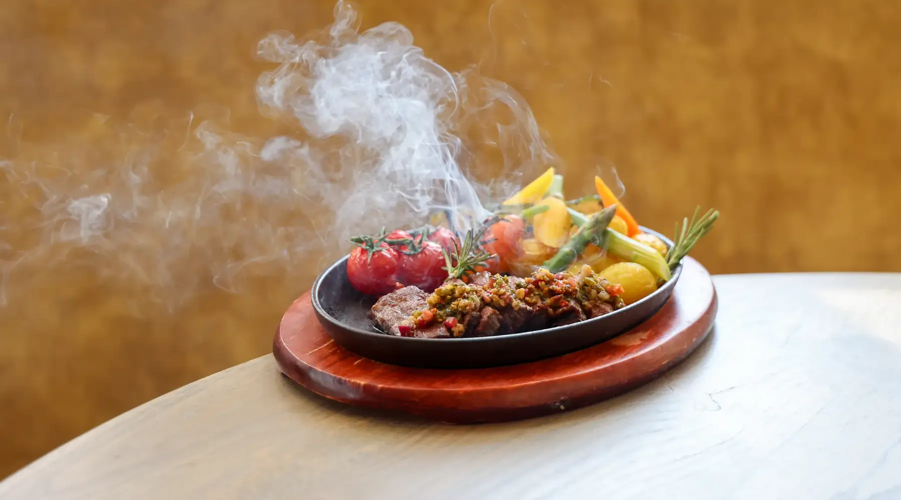 Steaming meat dish fresh from the kitchen of a Van der Valk restaurant