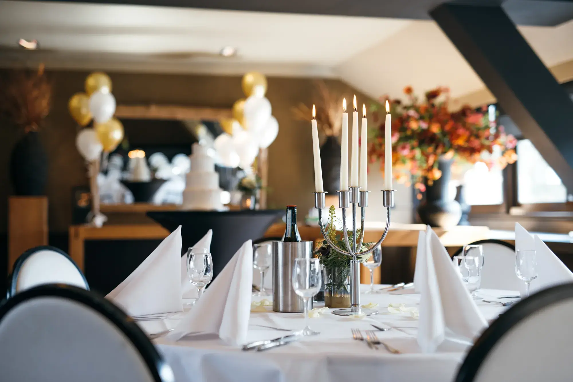Set table in an atmospheric room with white tablecloth.