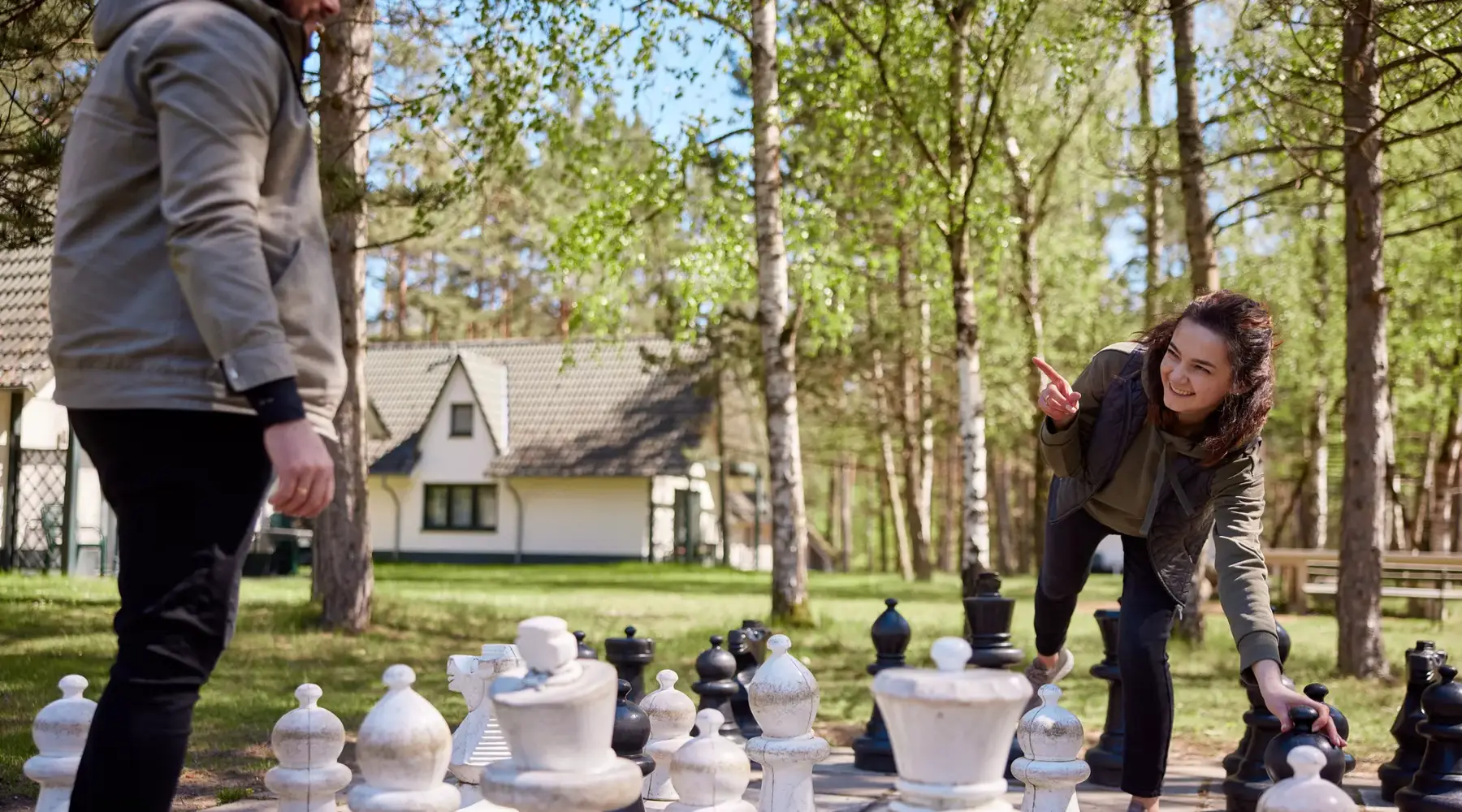 A secluded holiday home at Hotel Drewitz in the woods, surrounded by a spacious green lawn.
