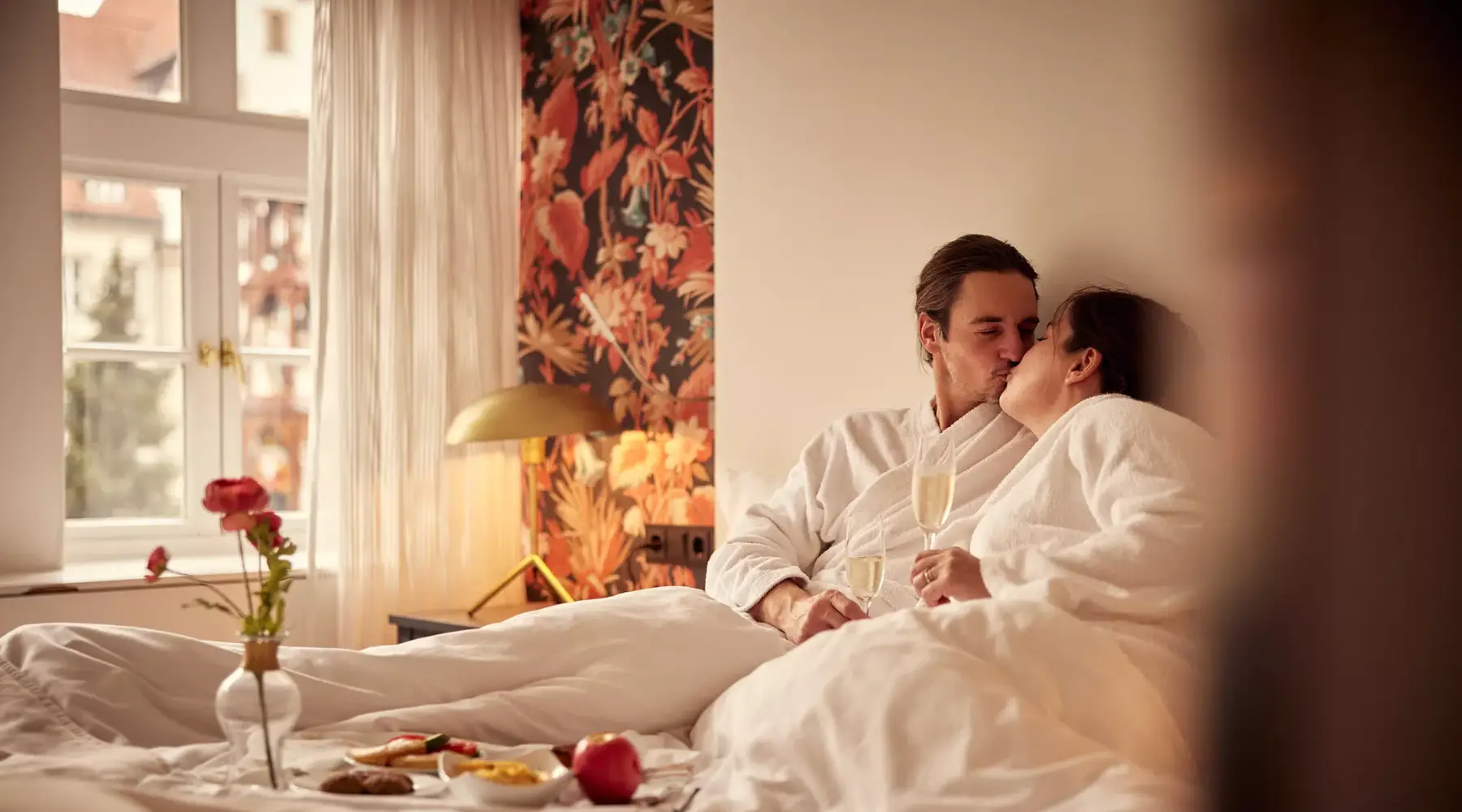 Couple in bathrobe with champagne