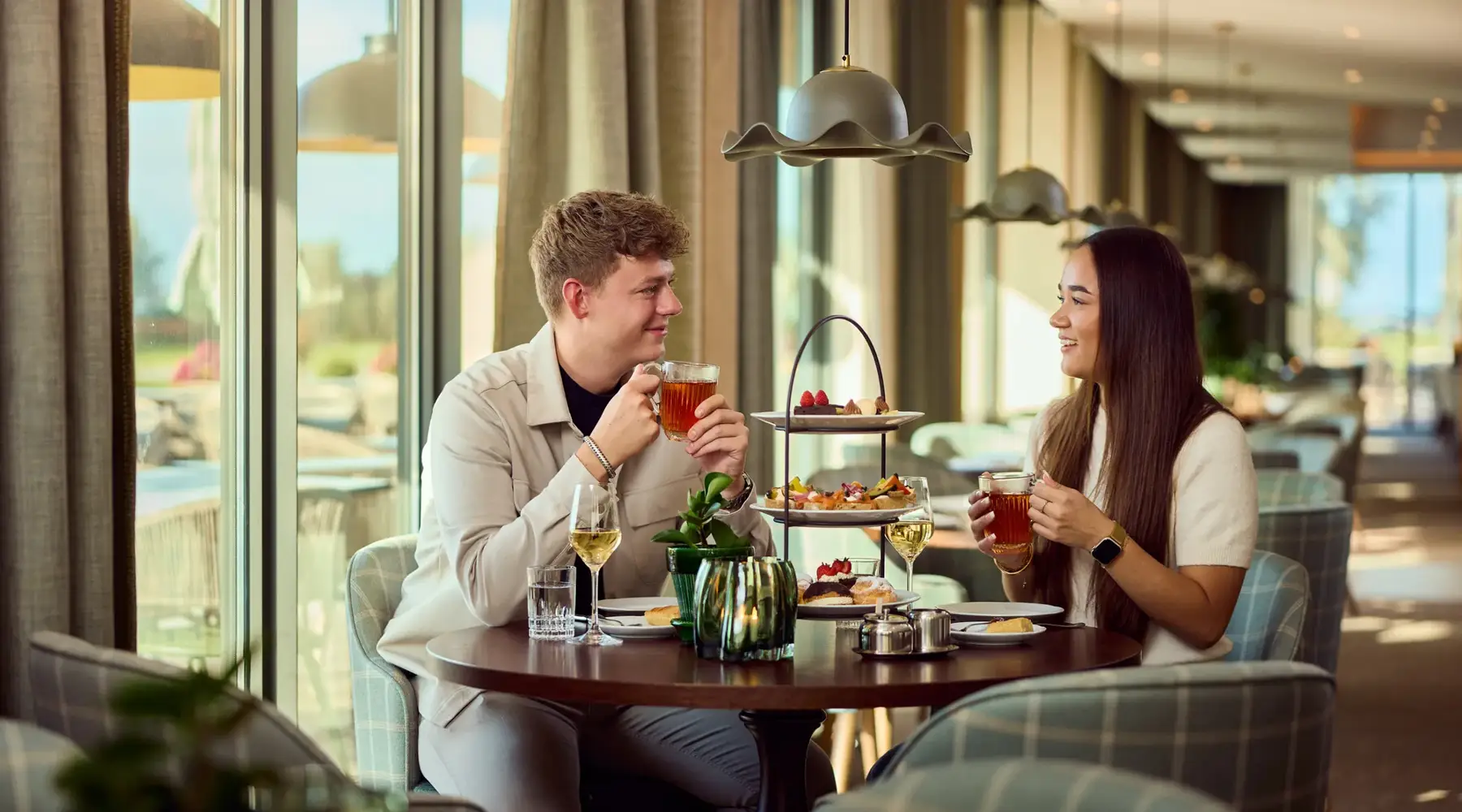 Couple has High tea with snacks on plates