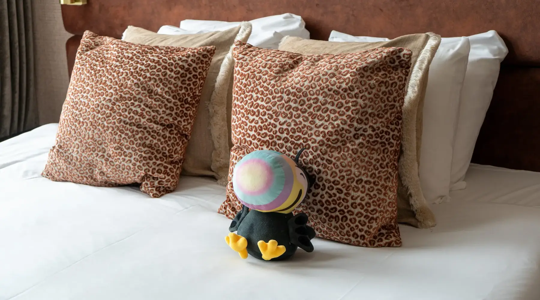 Tiki toucan on bed