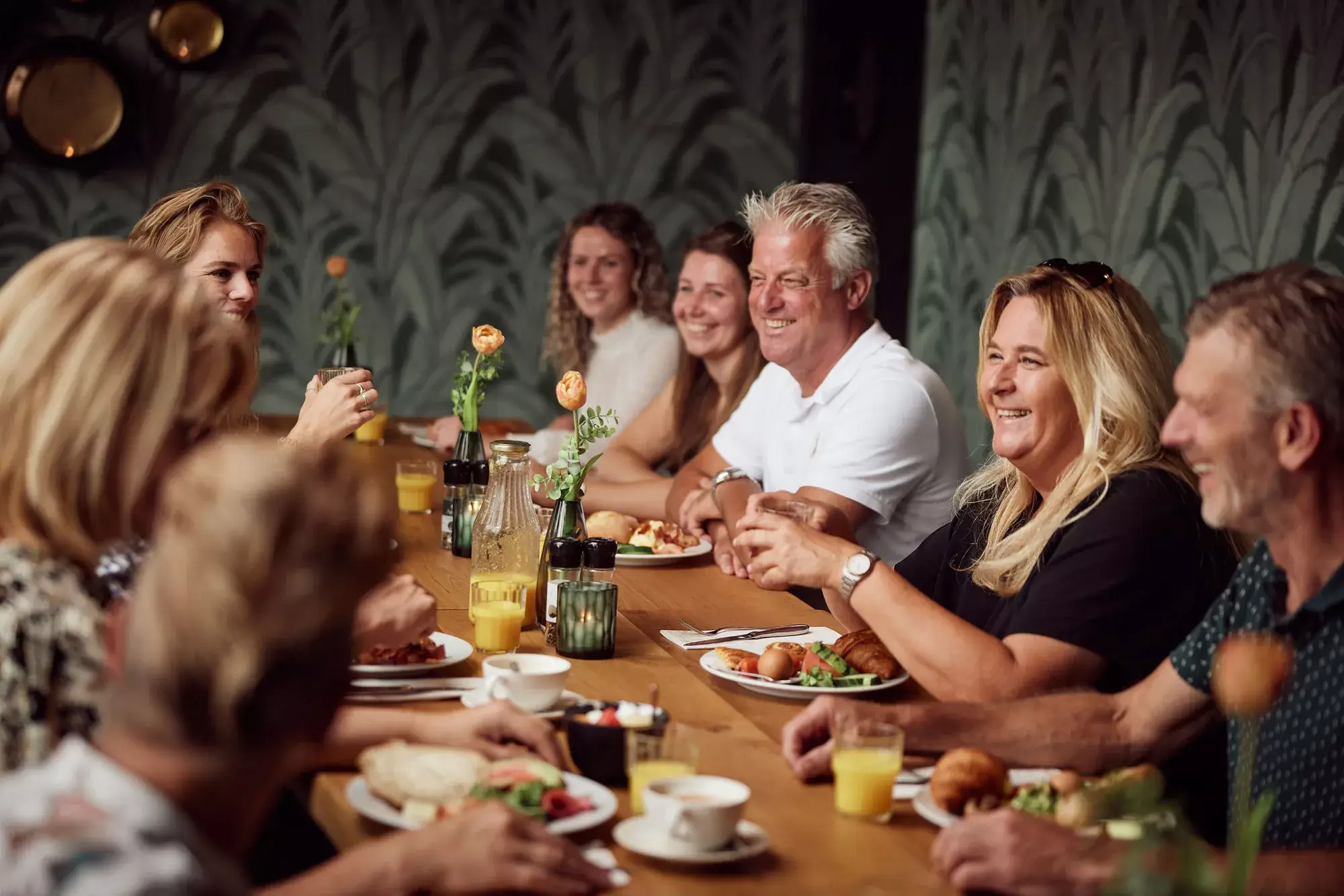 Een groep geniet van een maaltijd aan tafel