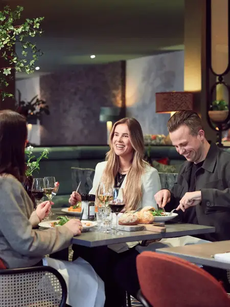 Friends eating in a Van der Valk restaurant