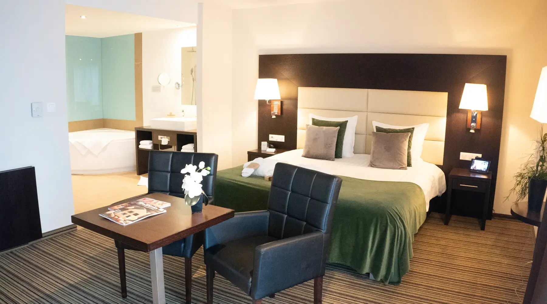 The bed in a suite at Hotel Charleroi Airport