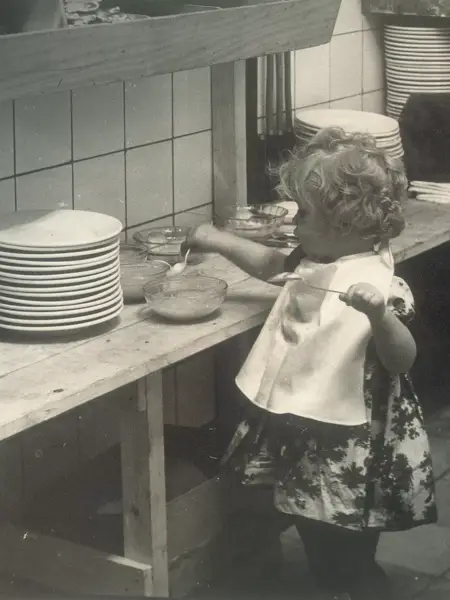 Old photo of a girl with applesauce at Van der Valk