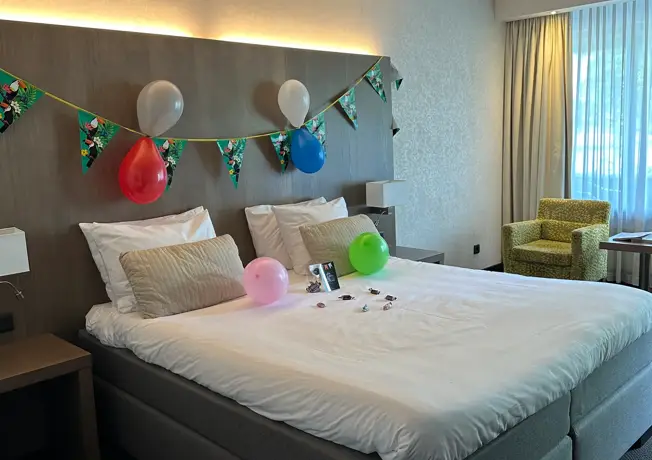 Bed with balloons and streamers