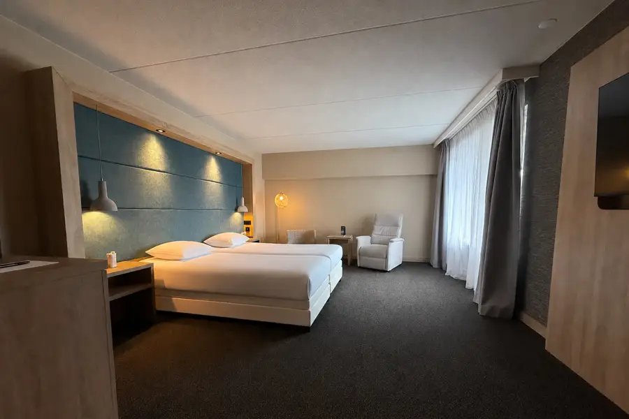 Chambre d'hôtel spacieuse et confortable avec lit double, coin salon et décoration moderne au Van der Valk Hotel Leusden-Amersfoort