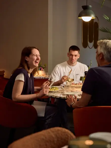 Friends eating in a Van der Valk restaurant