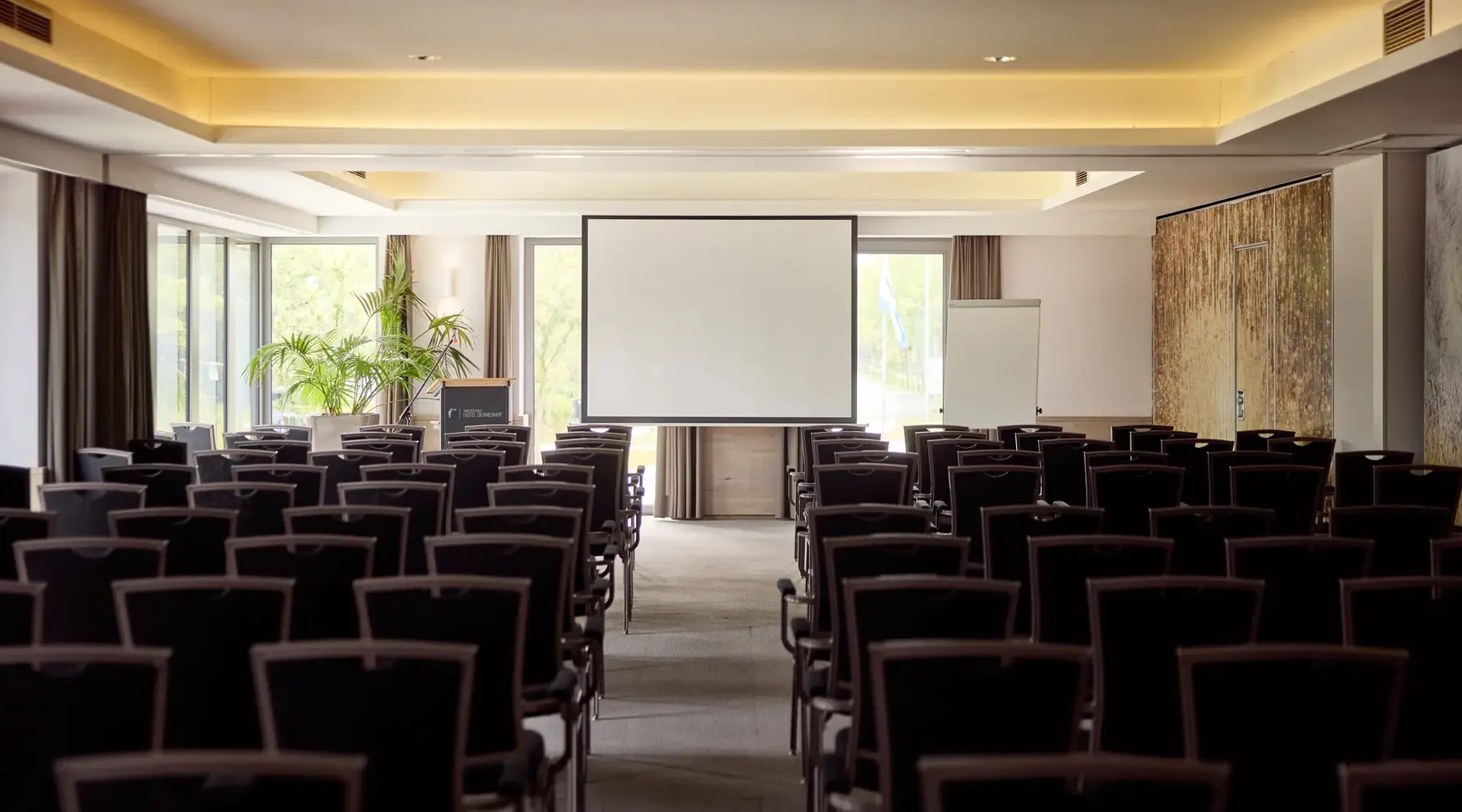 Room in Hotel Dennenhof with chairs and large screen