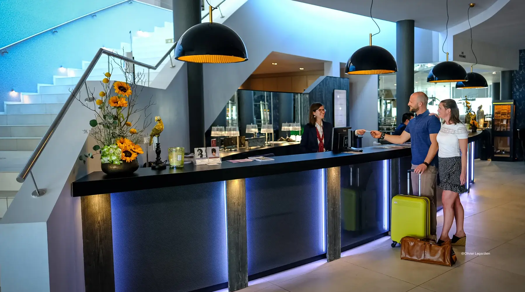 Friends checking in at the reception of a hotel