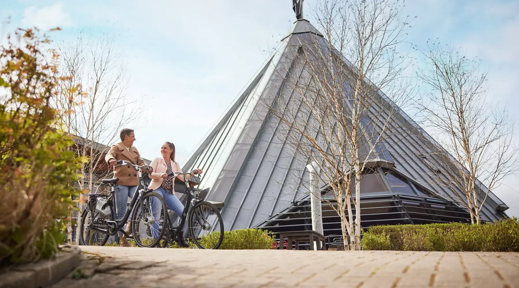 Moeder en dochter op de fiets voor Hotel Drachten