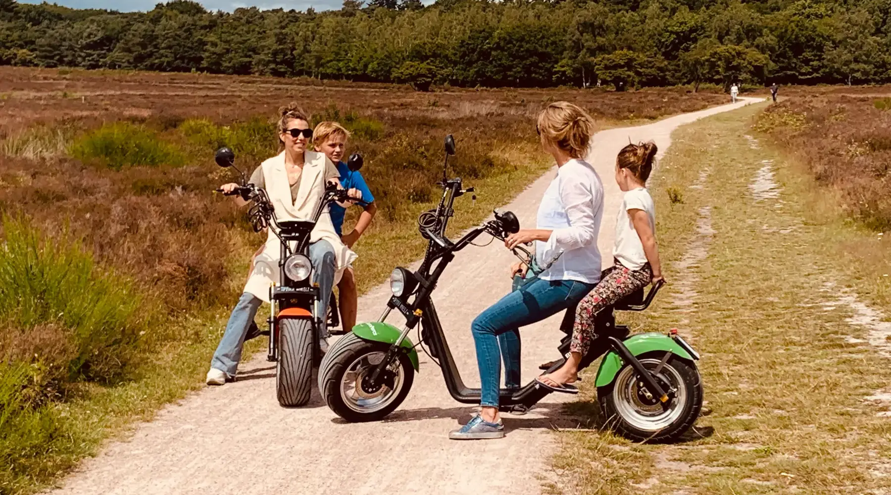Girlfriends on e-choppers on the Veluwe