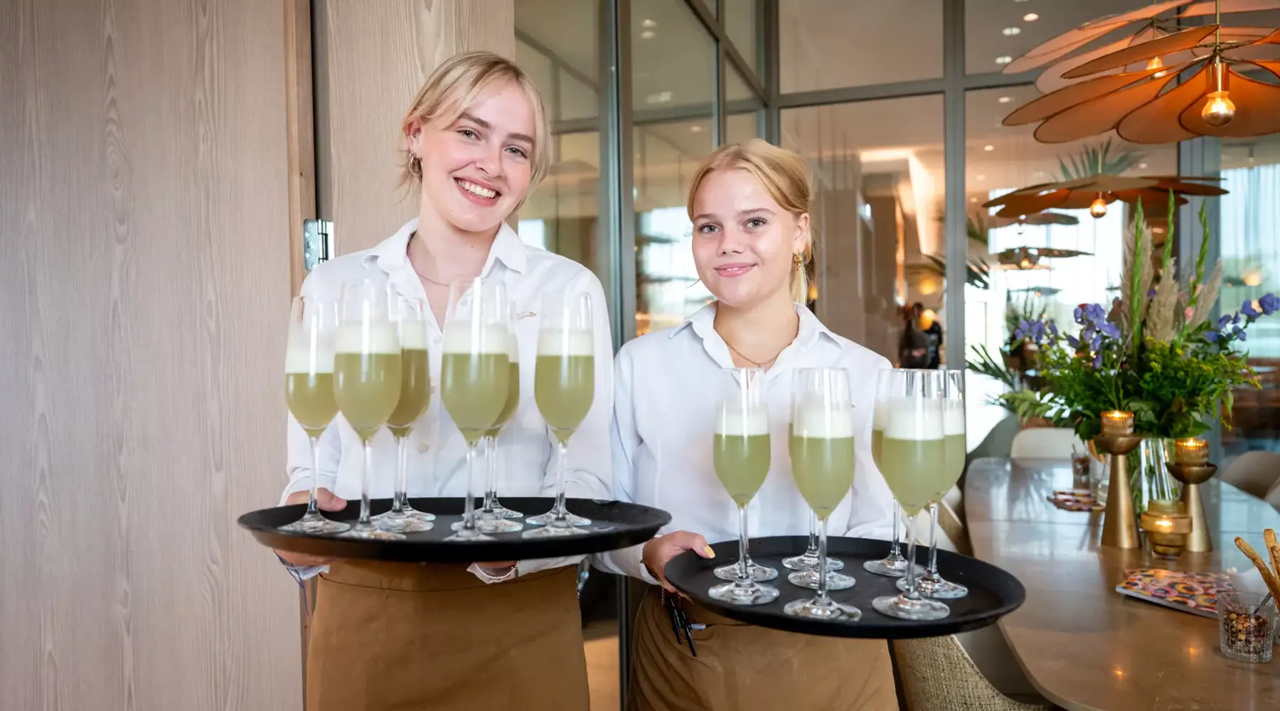 Two ladies with a tray of drinks