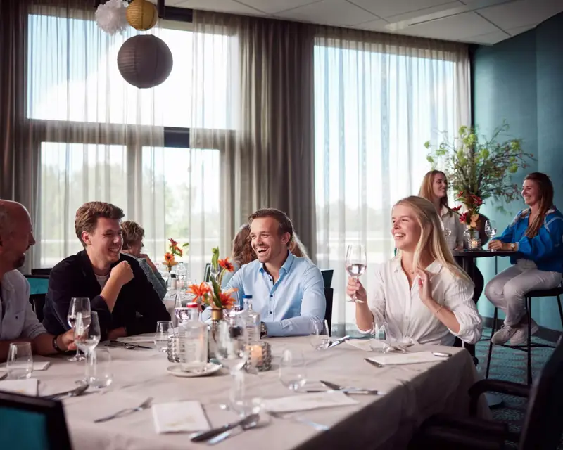 A group dinner in a meeting room in a hotel.
