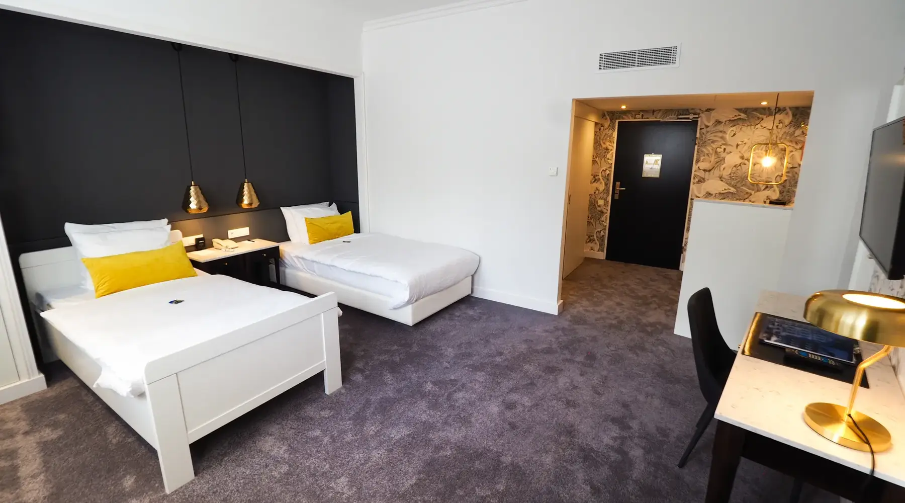 Spacious wheelchair-accessible twin room with two single beds and ample room to move around