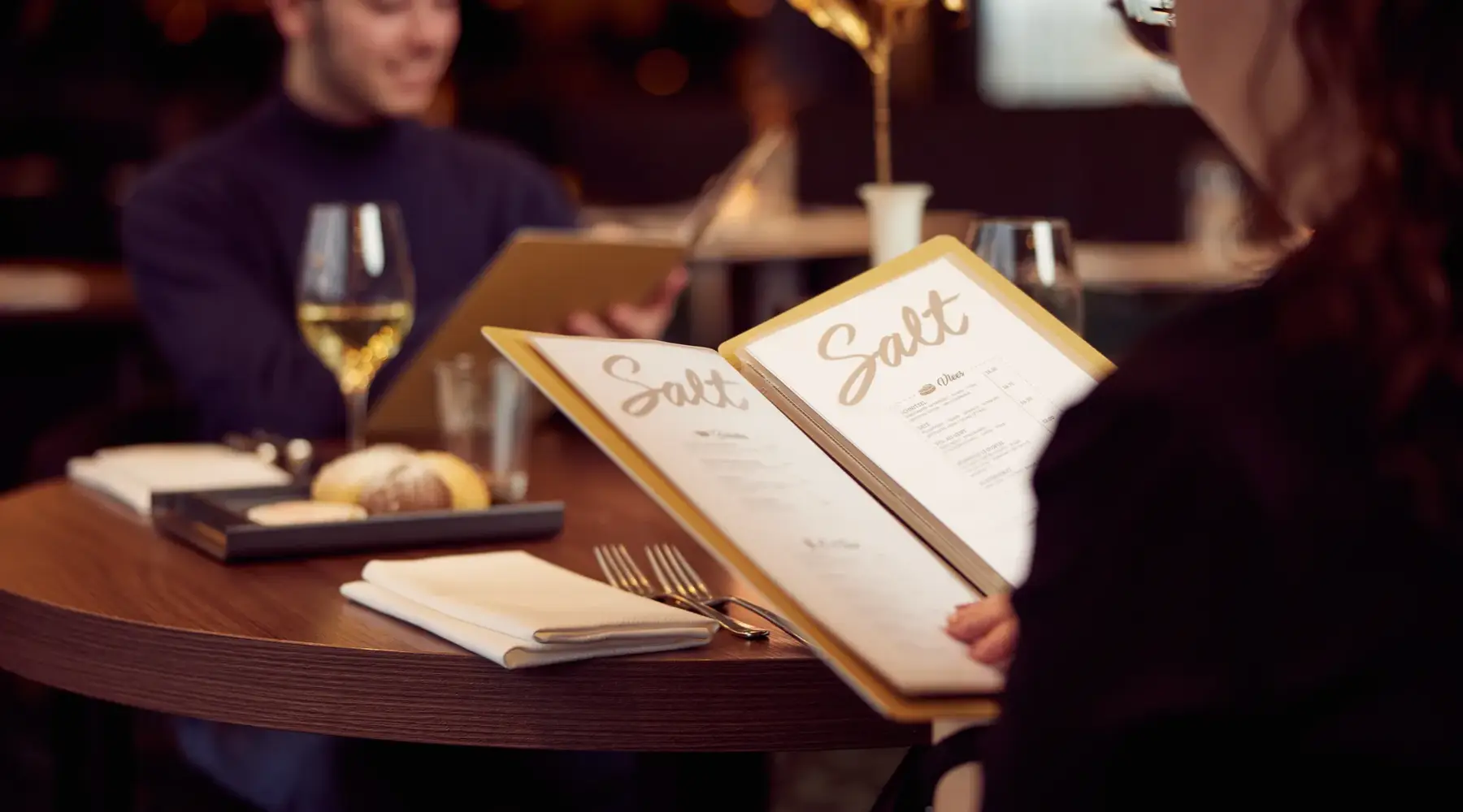 Person reads the menu card of restaurant Salt.