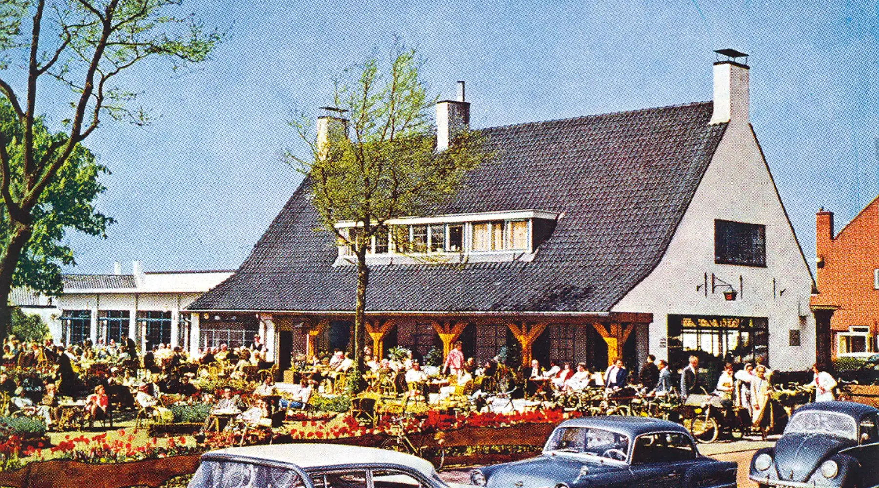Gerrit van der Valk in the early years next to a sign