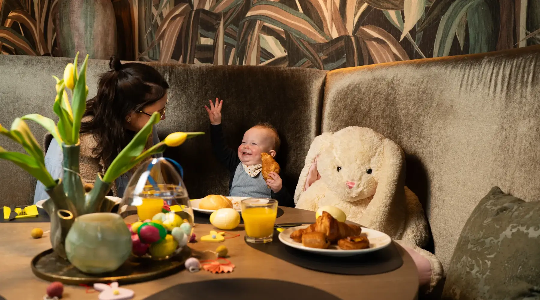 Mother having breakfast together with baby.