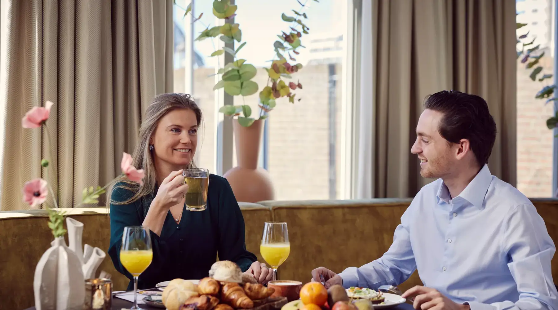 Woman and man having breakfast.