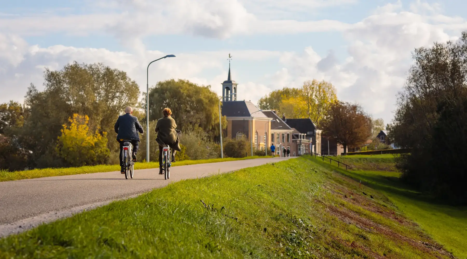 Man and woman cycling in the autumn
